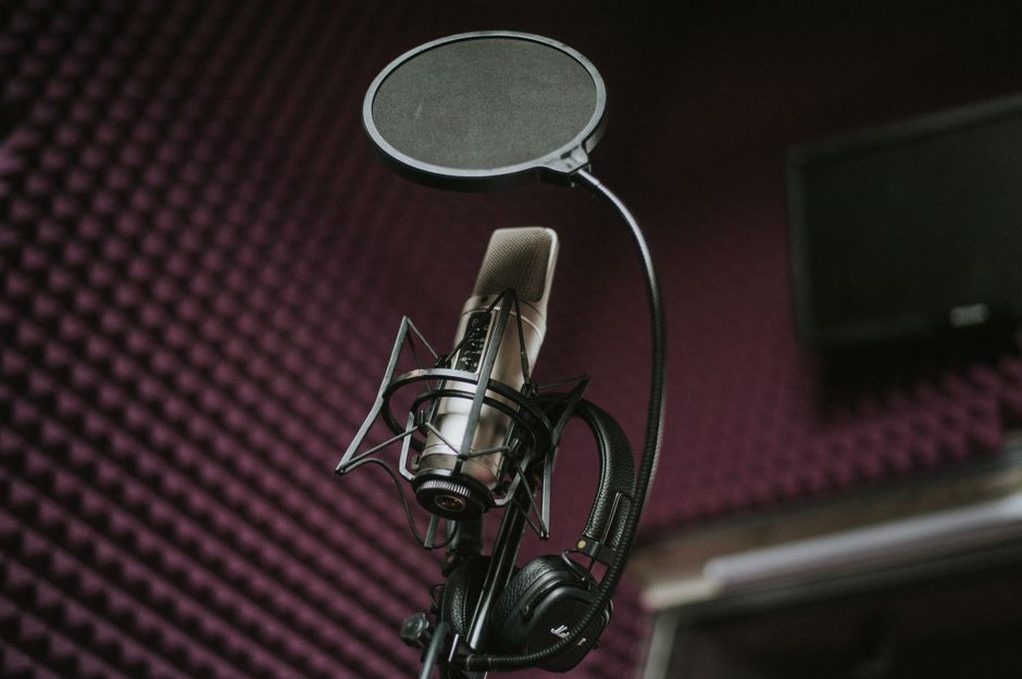 High-quality microphone and pop filter setup in a soundproof music studio.